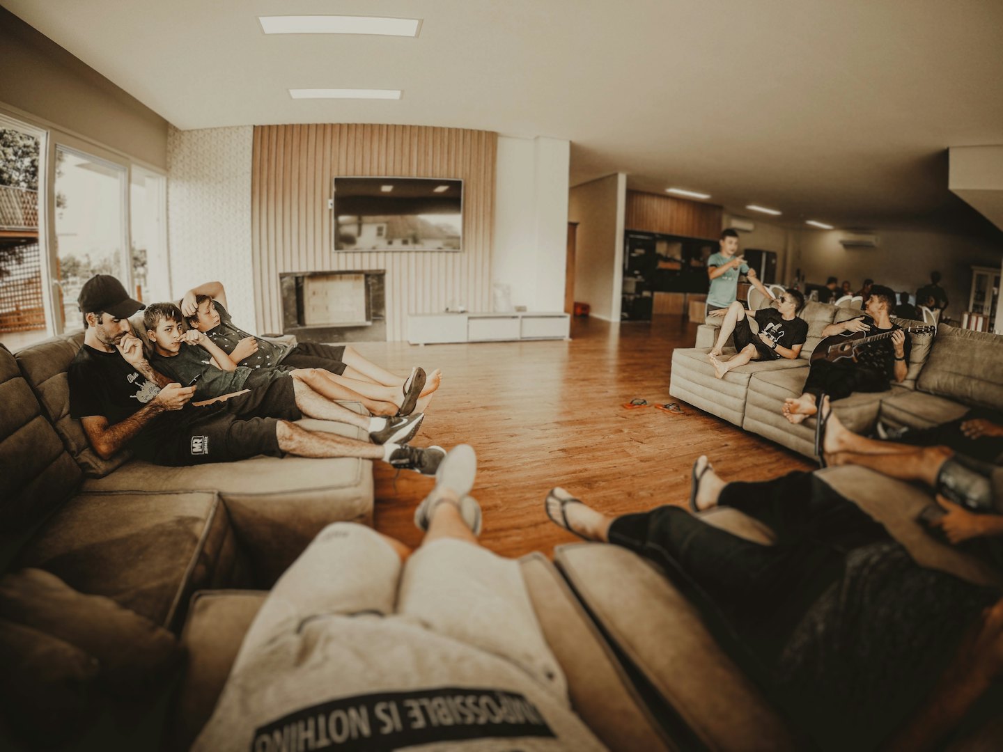 People relax and socialize inside a modern community lounge area.